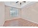 Bright bedroom features a ceiling fan, tray ceiling, and wood-look flooring at 62 E Serene Ave # 114, Las Vegas, NV 89123