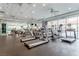 Bright gym with cardio equipment and mirrored walls with a view of the pool at 62 E Serene Ave # 114, Las Vegas, NV 89123