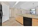 View of kitchen featuring light wood cabinets, granite countertops and black dishwasher at 62 E Serene Ave # 114, Las Vegas, NV 89123