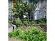 Beautiful landscaping featuring lush green plants and trees between stone buildings at 62 E Serene Ave # 114, Las Vegas, NV 89123