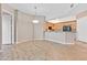 Living room featuring wood floors, ceiling fan, and view of the kitchen at 62 E Serene Ave # 114, Las Vegas, NV 89123