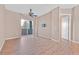 Living room featuring wood floors, ceiling fan, and sliding glass door to balcony at 62 E Serene Ave # 114, Las Vegas, NV 89123