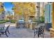 Community outdoor grill and seating area with lush landscaping at 62 E Serene Ave # 114, Las Vegas, NV 89123