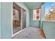 View of a condo patio area with a sliding glass door and concrete floor with leaves scattered about at 62 E Serene Ave # 114, Las Vegas, NV 89123