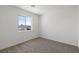 Neutral bedroom with carpet and a window allowing natural light, providing a comfortable and serene space at 6252 Blood Lily Ave, Las Vegas, NV 89122