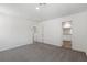Spacious bedroom with neutral carpeting, a ceiling light, and a door leading to an ensuite bathroom at 6252 Blood Lily Ave, Las Vegas, NV 89122