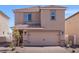 Two-story home with a stucco exterior, tile roof, and a two-car garage, complemented by a well-maintained front yard at 6252 Blood Lily Ave, Las Vegas, NV 89122