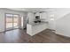 Bright kitchen with white cabinets, stainless steel appliances, an island with bar seating, and sliding door access to the backyard at 6252 Blood Lily Ave, Las Vegas, NV 89122