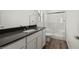 Modern bathroom boasting a sleek vanity with a dark countertop and a glass-enclosed shower at 6264 Blood Lily Ave, Las Vegas, NV 89122