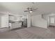 Open-concept living space with a ceiling fan and an adjacent kitchen with a center island at 6264 Blood Lily Ave, Las Vegas, NV 89122