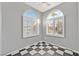 Cozy bedroom with arched windows, plantation shutters, and stylish checkerboard flooring at 6652 Goldencreek Way, Las Vegas, NV 89108