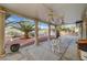 Covered back patio featuring ceiling fans, stone columns and desert landscaping at 6870 Laronda Ln, Las Vegas, NV 89156