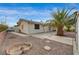 Backyard featuring a desert landscape, large patio area, and mature palm tree at 6870 Laronda Ln, Las Vegas, NV 89156