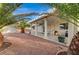 Backyard featuring covered patio with stone columns and desert landscaping at 6870 Laronda Ln, Las Vegas, NV 89156