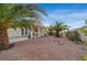 Backyard featuring a desert landscape, covered patio, and mature palm trees at 6870 Laronda Ln, Las Vegas, NV 89156