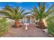 Backyard featuring a desert landscape, bird bath, covered patio and mature palm trees at 6870 Laronda Ln, Las Vegas, NV 89156