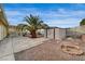 Backyard featuring a storage shed, covered patio, desert landscape and mature palm tree at 6870 Laronda Ln, Las Vegas, NV 89156