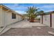 Backyard featuring a storage shed, large patio area, and mature palm tree at 6870 Laronda Ln, Las Vegas, NV 89156