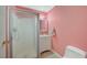 Pink bathroom featuring glass enclosed shower, vanity and bright lighting at 6870 Laronda Ln, Las Vegas, NV 89156