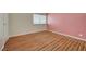 Bright bedroom featuring wood flooring, a window, and neutral paint at 6870 Laronda Ln, Las Vegas, NV 89156