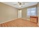 Bedroom features a ceiling fan, wood-look floors, and a window with natural light at 6870 Laronda Ln, Las Vegas, NV 89156