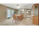 A large dining room featuring a classic table and chairs setup, with an open view to the adjacent kitchen at 6870 Laronda Ln, Las Vegas, NV 89156