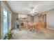 Spacious dining room with large table and chairs, access to the patio, and views of the kitchen at 6870 Laronda Ln, Las Vegas, NV 89156
