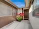 Inviting front entrance featuring mature bougainvillea and a decorative shell chime at 6870 Laronda Ln, Las Vegas, NV 89156