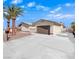 Picture of charming single-story home, driveway, garage, desert landscaping, and light-colored stucco at 6870 Laronda Ln, Las Vegas, NV 89156