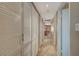 Hallway featuring shuttered closet doors and leading to kitchen at end of hall at 6870 Laronda Ln, Las Vegas, NV 89156