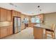 Charming kitchen with granite countertops, stainless steel appliances, and a functional center island with bar stool seating at 6870 Laronda Ln, Las Vegas, NV 89156