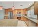 Eat-in kitchen showcasing a granite counter, an island, stainless steel appliances, and modern lighting at 6870 Laronda Ln, Las Vegas, NV 89156