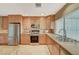 Bright kitchen features stainless steel appliances, granite counters, light cabinets, and a window over the sink at 6870 Laronda Ln, Las Vegas, NV 89156
