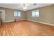 Bright living room featuring wood flooring, a ceiling fan, and natural light at 6870 Laronda Ln, Las Vegas, NV 89156