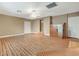 Open living room featuring wood flooring, a ceiling fan, and natural light at 6870 Laronda Ln, Las Vegas, NV 89156
