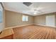 Bright living room featuring wood flooring, a ceiling fan, and natural light at 6870 Laronda Ln, Las Vegas, NV 89156