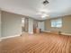 Spacious living room featuring wood flooring, a ceiling fan, and natural light at 6870 Laronda Ln, Las Vegas, NV 89156
