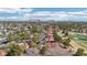 Picturesque aerial view overlooking community homes, mature trees, and a golf course with a pond in the background at 7315 Mission Hills Dr, Las Vegas, NV 89113