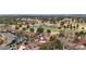 Picturesque aerial view overlooking community homes, mature trees, and a golf course with a pond in the background at 7315 Mission Hills Dr, Las Vegas, NV 89113
