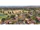 Picturesque aerial view overlooking community homes, mature trees, and a golf course in the background at 7315 Mission Hills Dr, Las Vegas, NV 89113