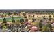 Picturesque aerial view overlooking community homes, mature trees, and a golf course with a pond in the background at 7315 Mission Hills Dr, Las Vegas, NV 89113