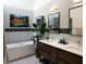 Bright bathroom featuring a modern tub, double vanity, and contemporary fixtures at 7315 Mission Hills Dr, Las Vegas, NV 89113