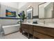 Luxurious bathroom with a soaking tub, double vanity, and modern fixtures at 7315 Mission Hills Dr, Las Vegas, NV 89113