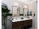 Bright bathroom featuring double sinks, modern lighting, and stylish fixtures at 7315 Mission Hills Dr, Las Vegas, NV 89113