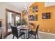 Bright dining area features a modern light fixture, unique wall decor, and sliding door access to the outside at 7315 Mission Hills Dr, Las Vegas, NV 89113