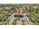 Aerial view of the community entrance featuring palm trees, lush landscaping, and a gated entry at 7315 Mission Hills Dr, Las Vegas, NV 89113