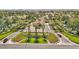 An aerial view of a landscaped entrance with palm trees leading to the building under a red tile roof at 7315 Mission Hills Dr, Las Vegas, NV 89113