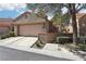 Charming home with a neutral exterior, tiled roof, well-manicured landscaping, and a two-car garage at 7315 Mission Hills Dr, Las Vegas, NV 89113