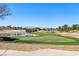 View of the golf course, lake, and surrounding houses with mature trees at 7315 Mission Hills Dr, Las Vegas, NV 89113