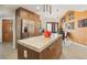 Beautiful kitchen featuring a large island, stainless steel appliances, custom wood cabinets and tiled floors at 7315 Mission Hills Dr, Las Vegas, NV 89113